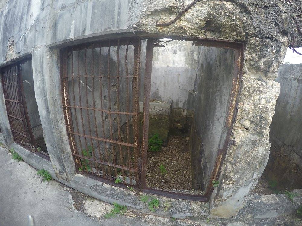 a metal gate in a stone wall
