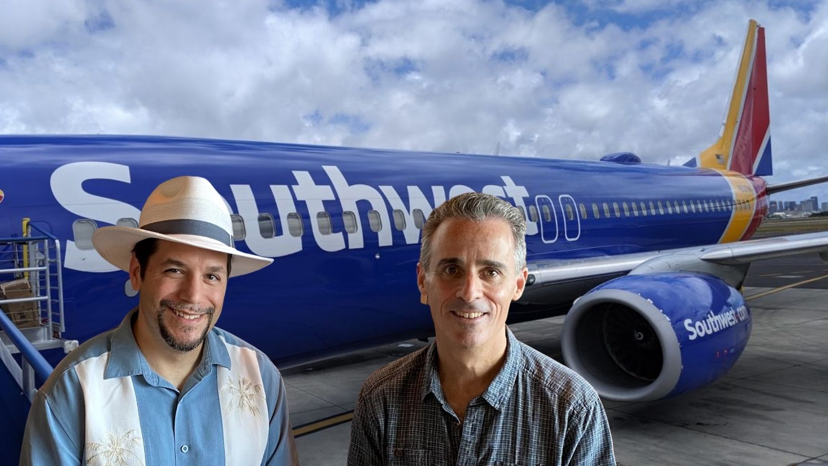 two men standing in front of a plane