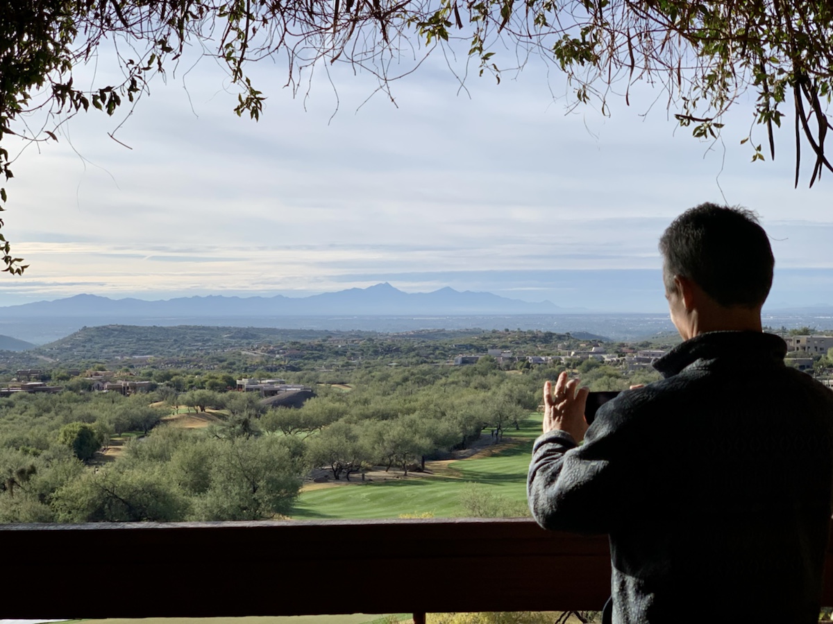 a man taking a picture of a landscape