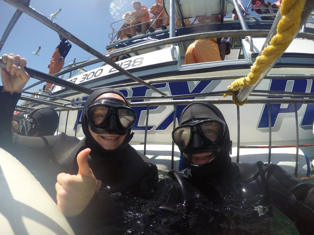 two people in scuba gear on a boat