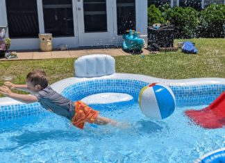 a boy in a pool with a ball