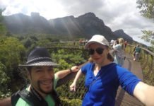 (EXPIRED) Cape Town in nonstop business class from 104K round trip for up to 4 passengers a man and woman taking a selfie on a bridge over a forest