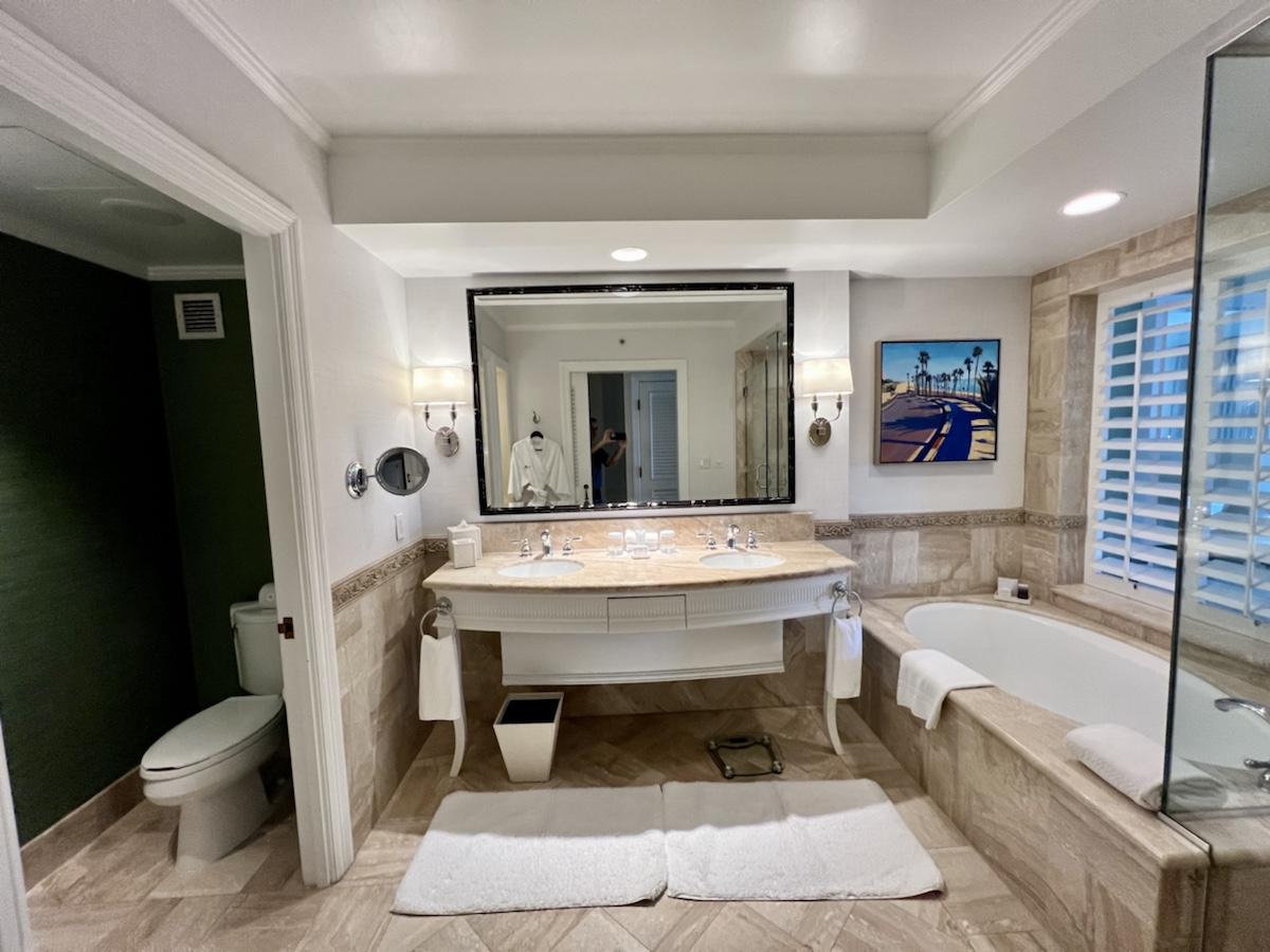 a bathroom with a large mirror and tub