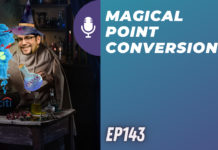 a man in a hat and robe pouring liquid into a glass