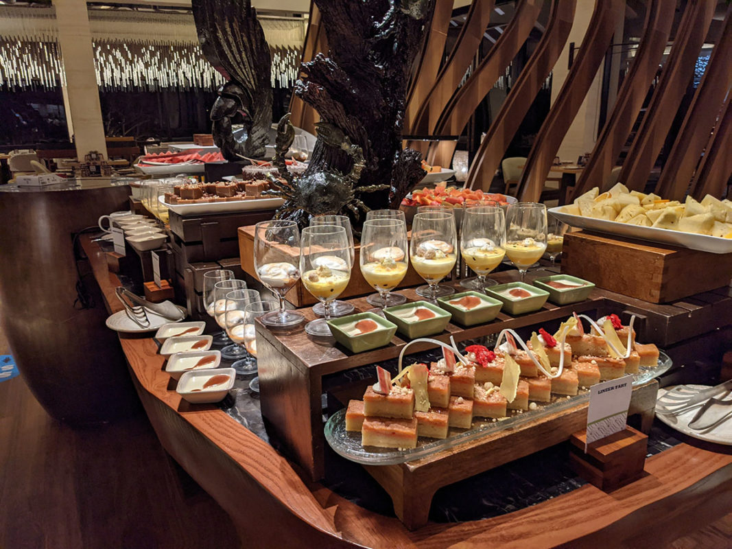 a table of food with glasses of desserts