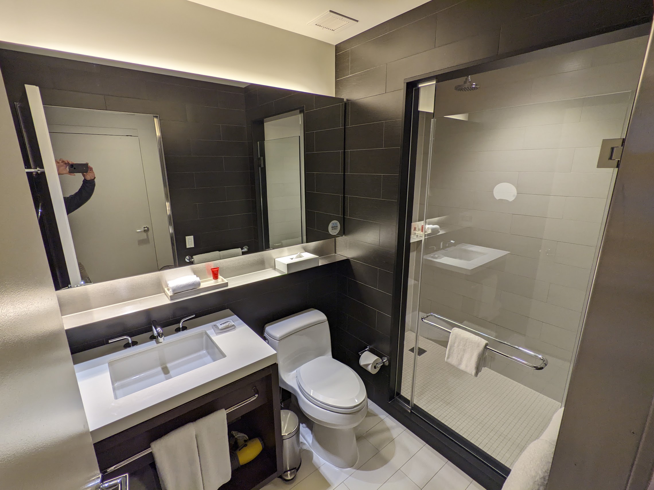 a bathroom with a glass shower door and a toilet