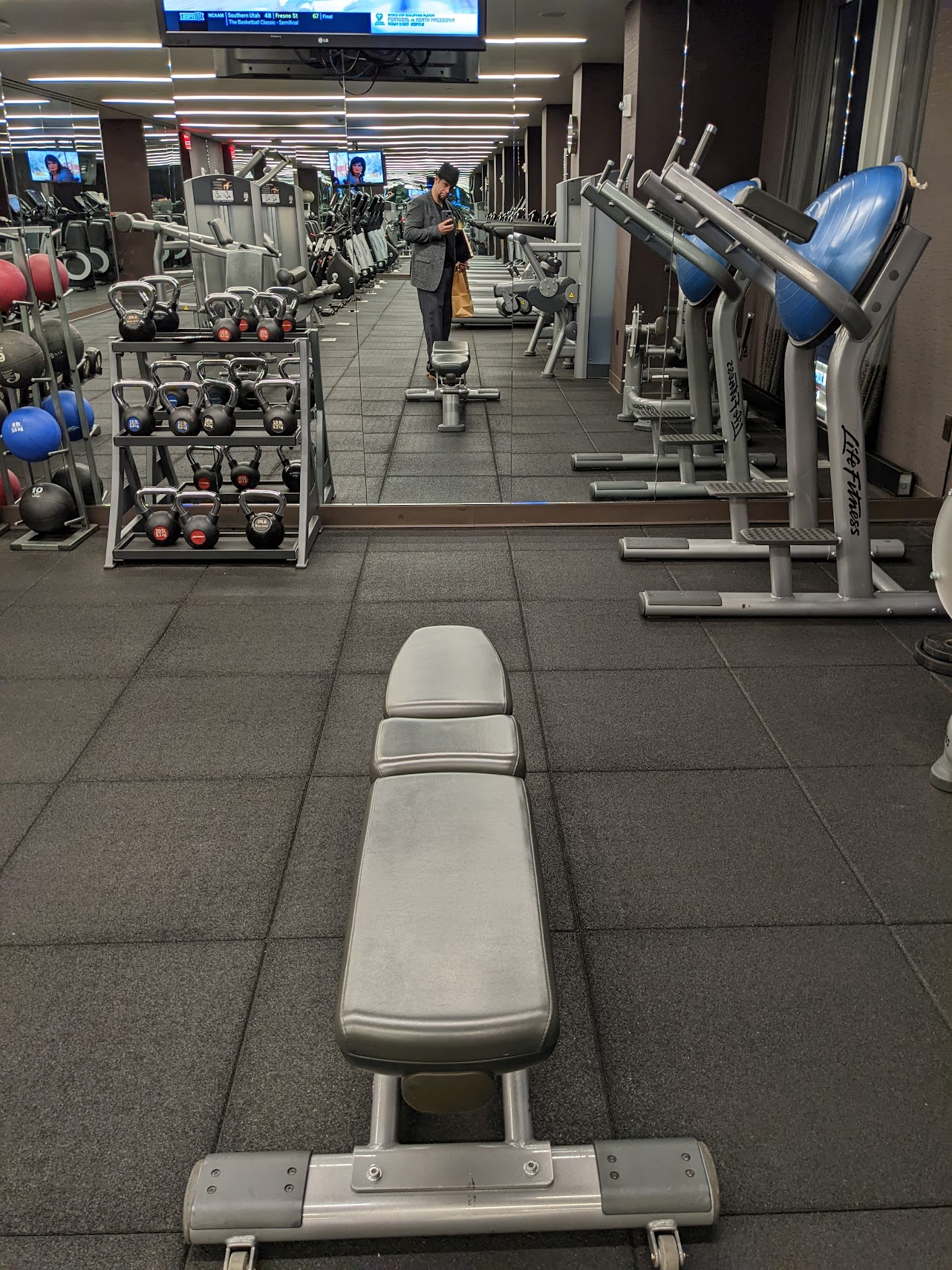 a mirror of a gym with exercise equipment