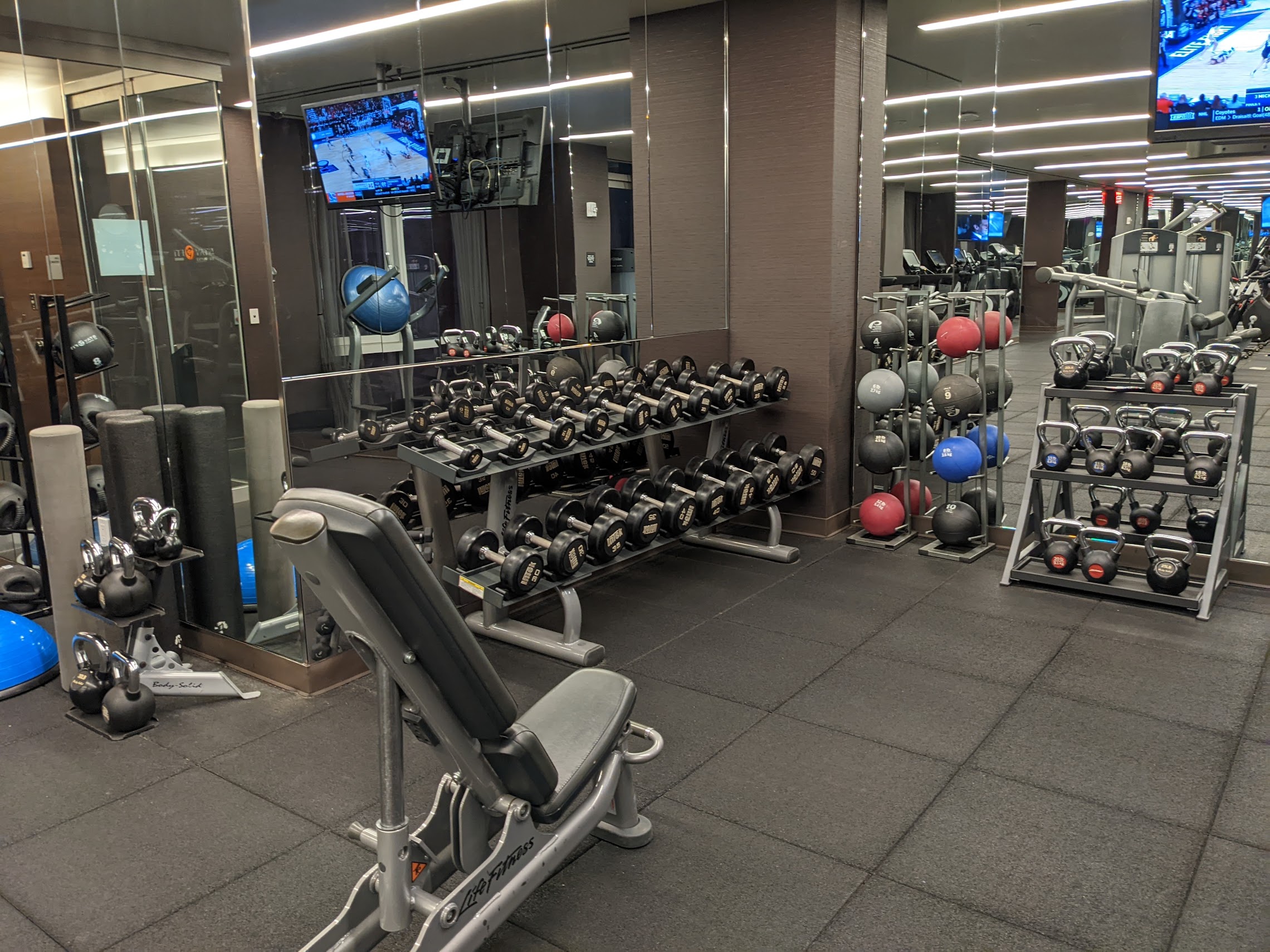 a room with a large group of weights and a mirror