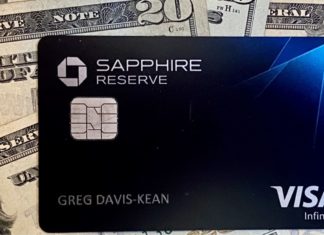 a black credit card on top of money