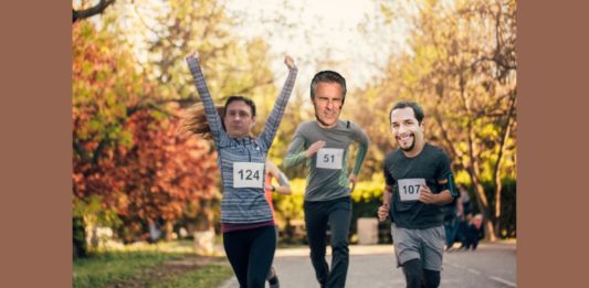 a group of people running on a road with numbers on their faces