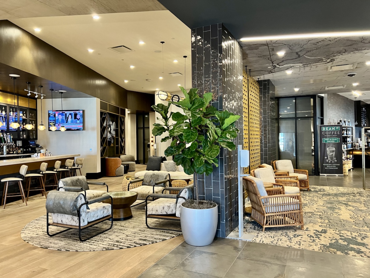 a lobby with chairs and a plant