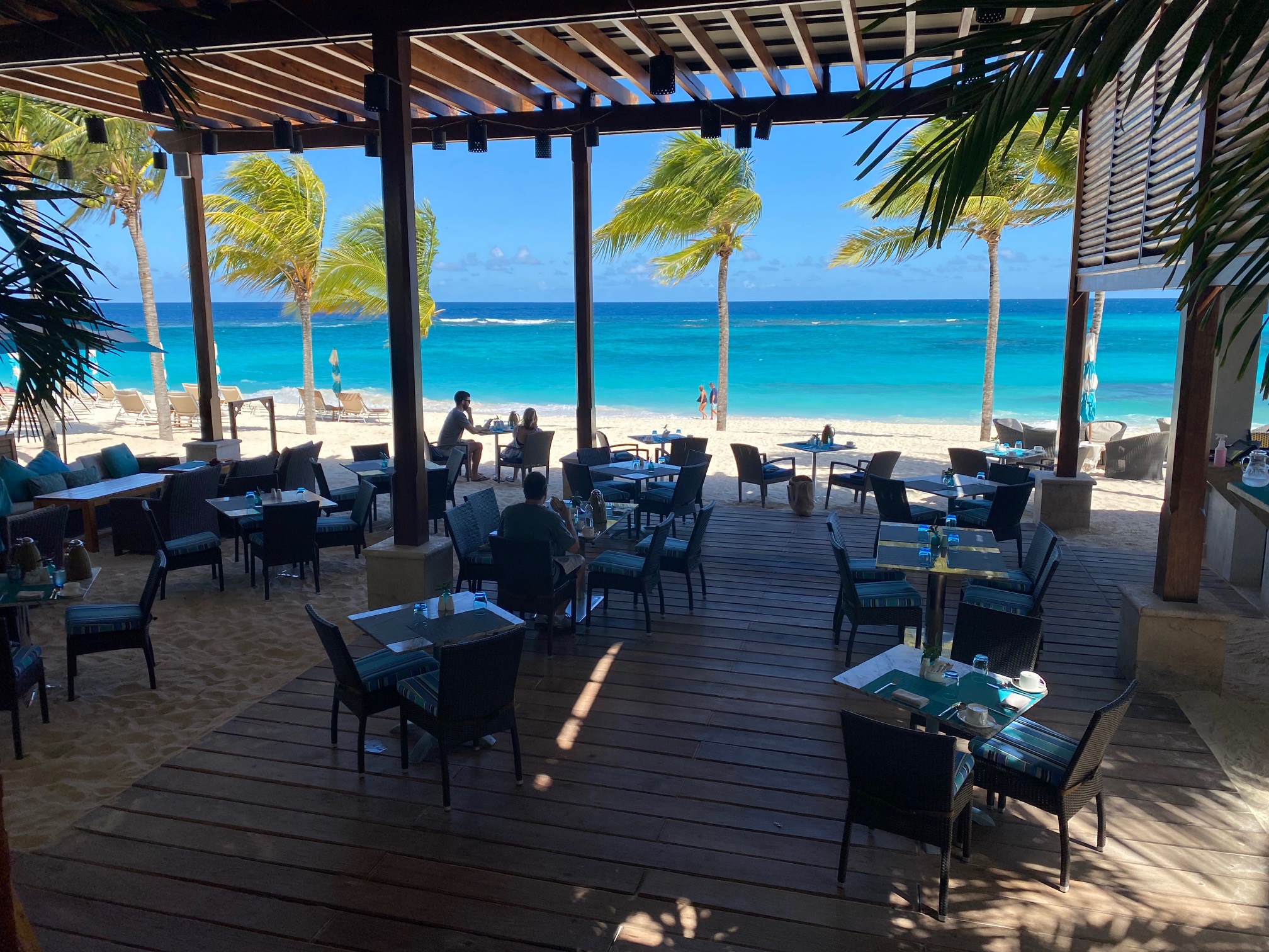 a restaurant with tables and chairs on a beach