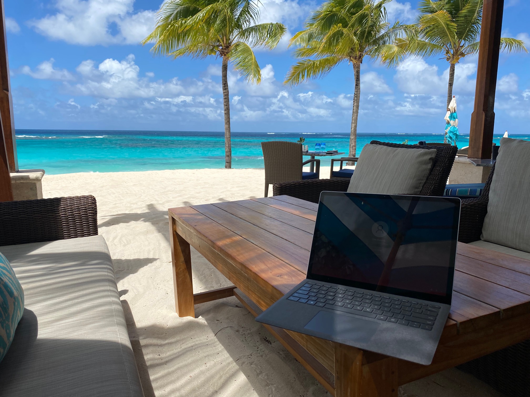a laptop on a table on a beach