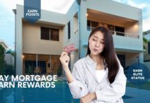 a woman holding a credit card in front of a building