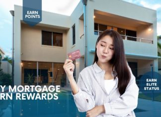 a woman holding a credit card in front of a building