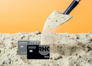 a shovel pouring sand into a pile of credit cards