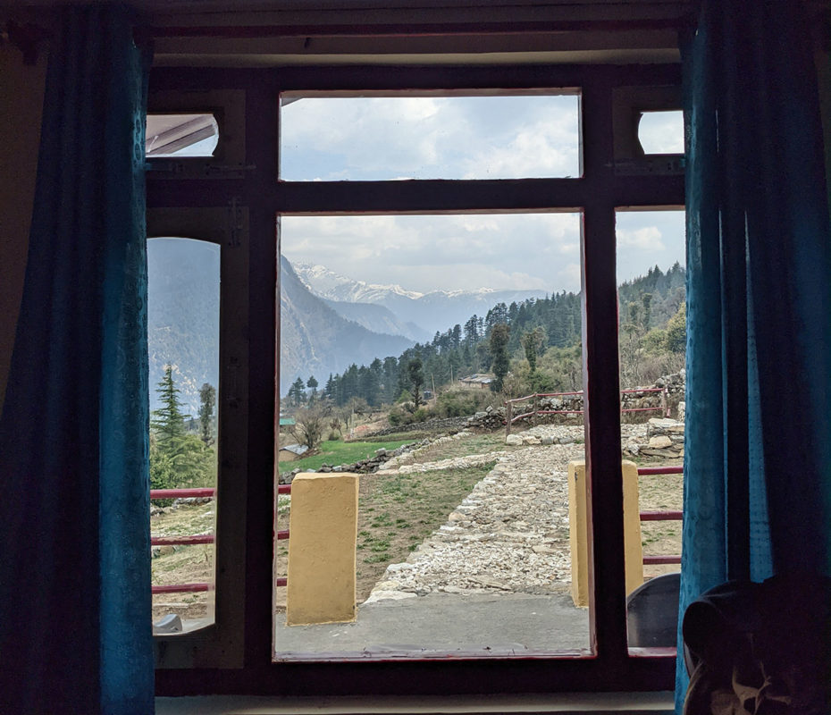 a window with a view of mountains and trees