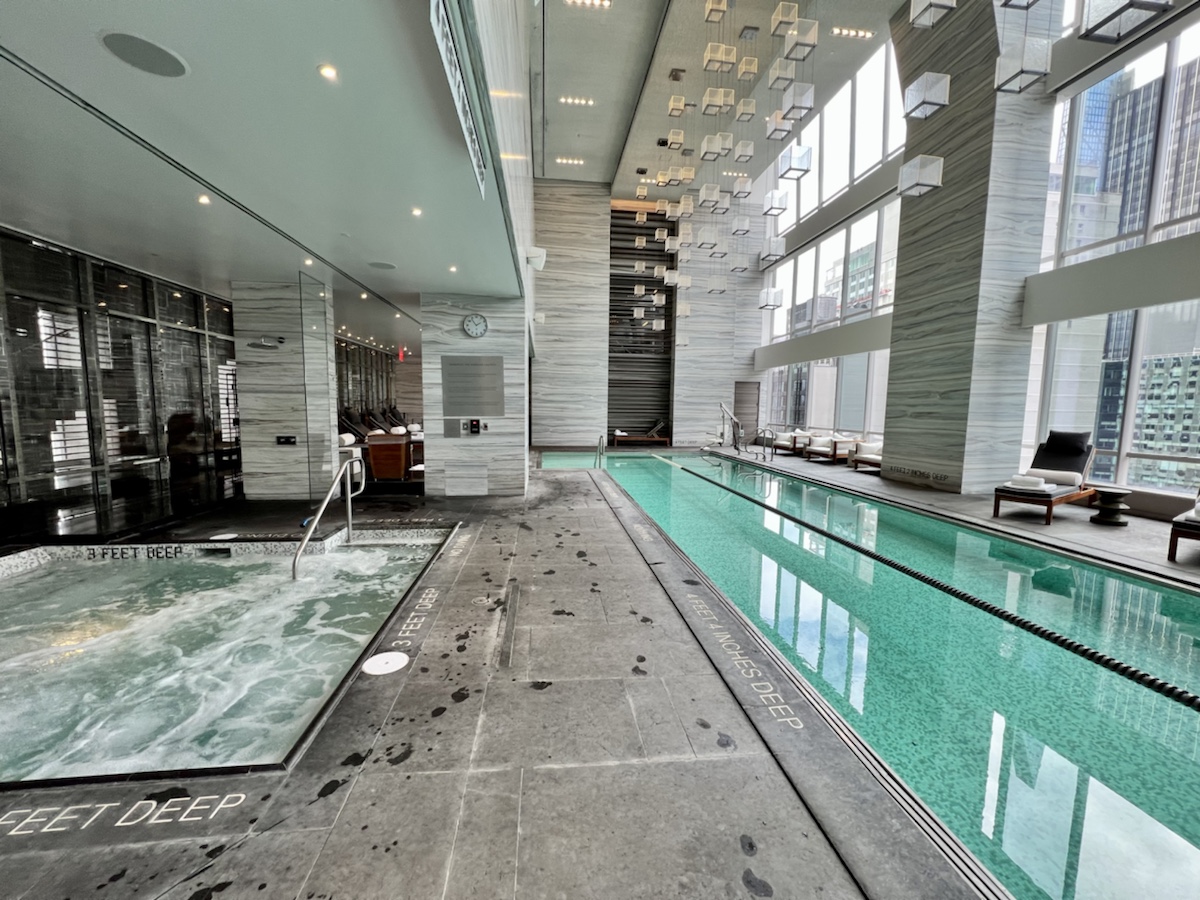 a indoor pool with a large tub