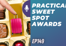 a finger pointing at a pink suitcase