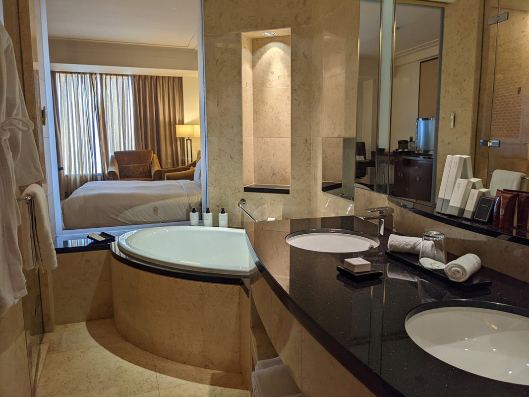 a bathroom with a large tub and a large mirror