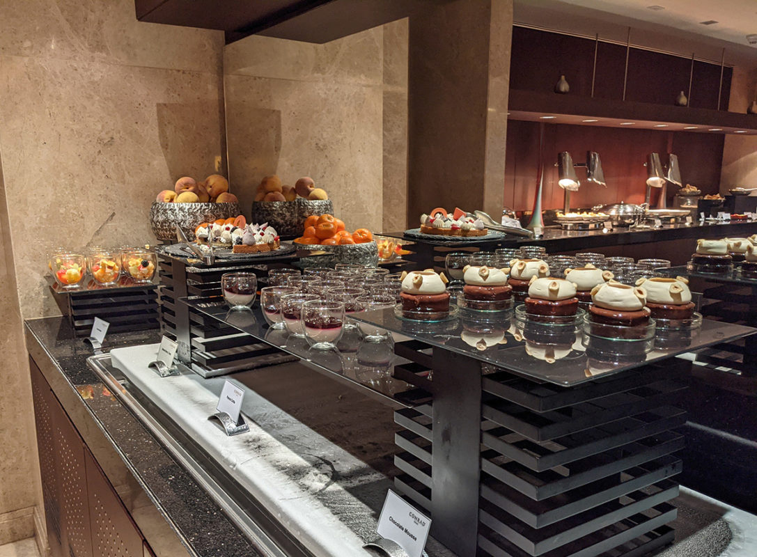 a buffet table with desserts and fruit