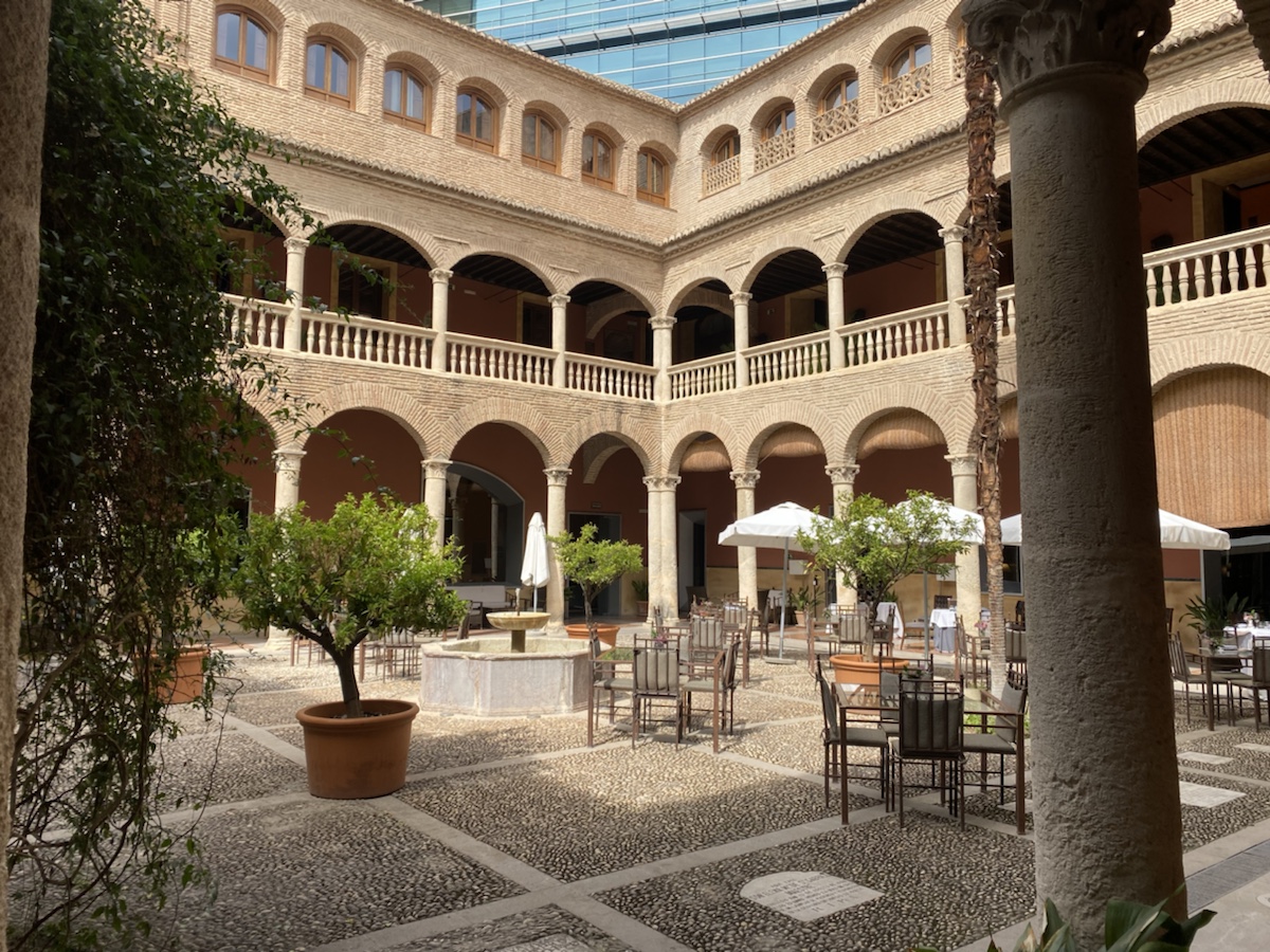 a courtyard with tables and chairs