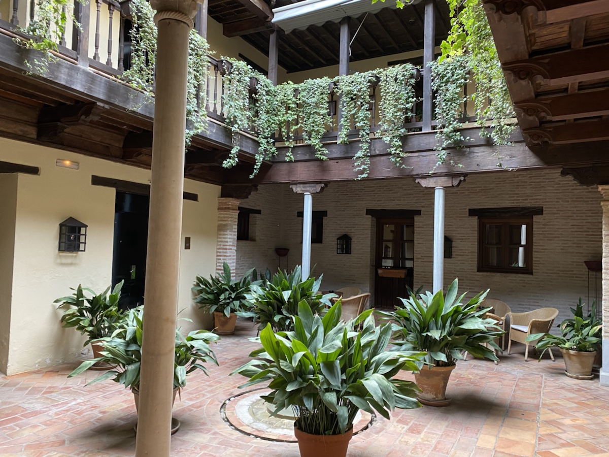 a courtyard with plants in pots