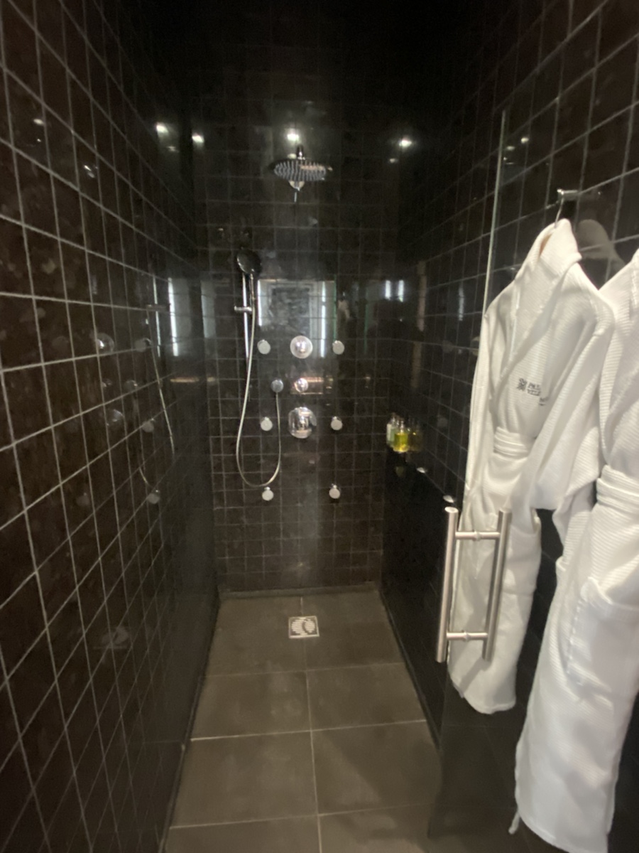 a shower with a white robe on a swinger