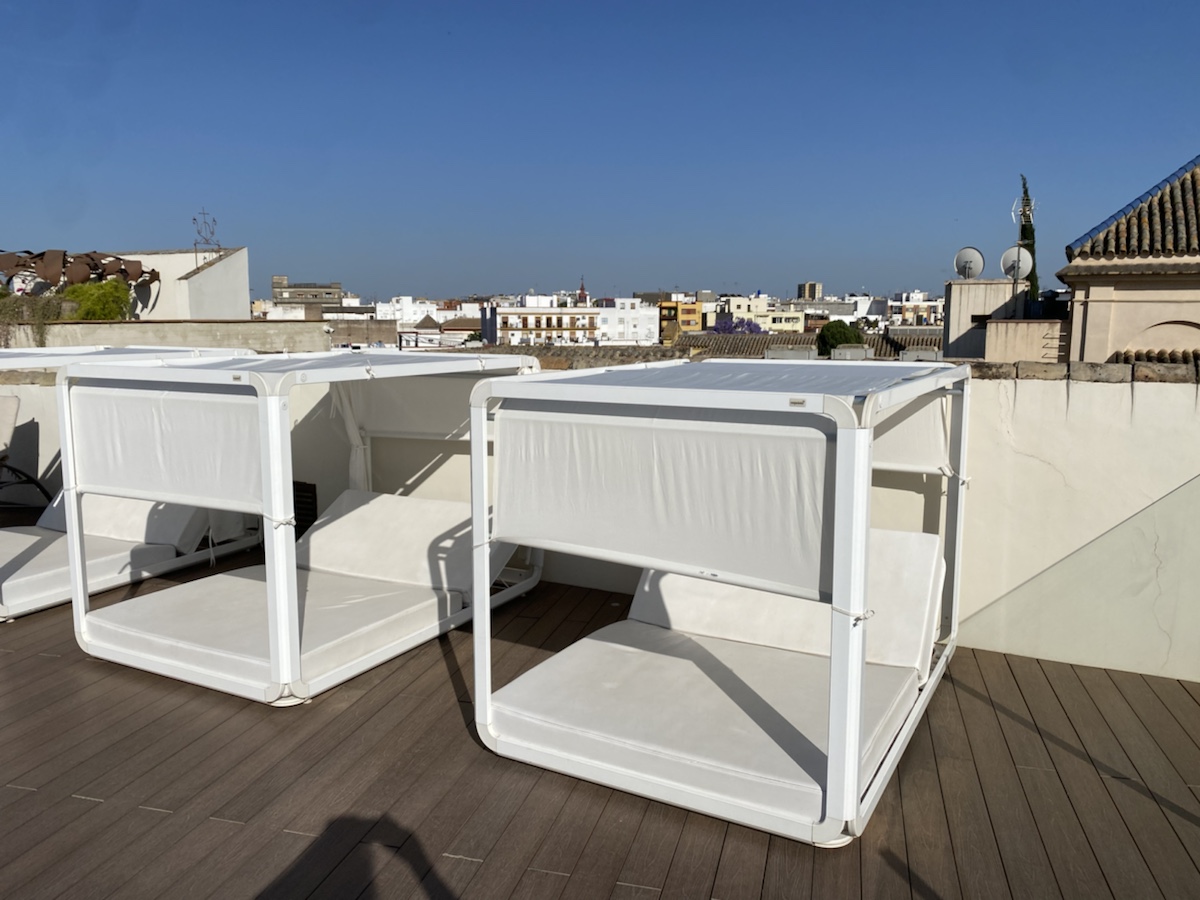 a white beds on a rooftop