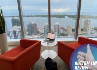 a room with a view of a city and a laptop