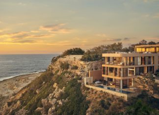 a building on a cliff overlooking the ocean