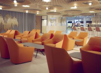 a room with orange chairs and tables