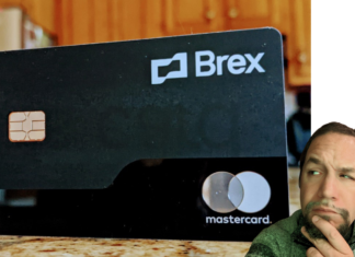 a man sitting on a counter with a credit card