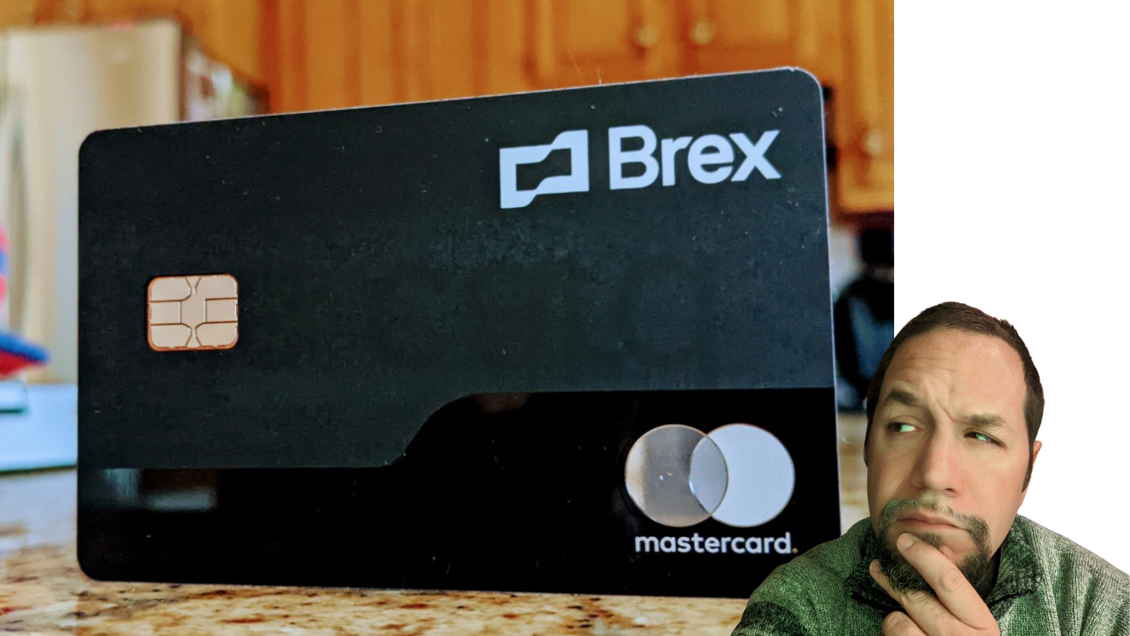a man sitting on a counter with a credit card