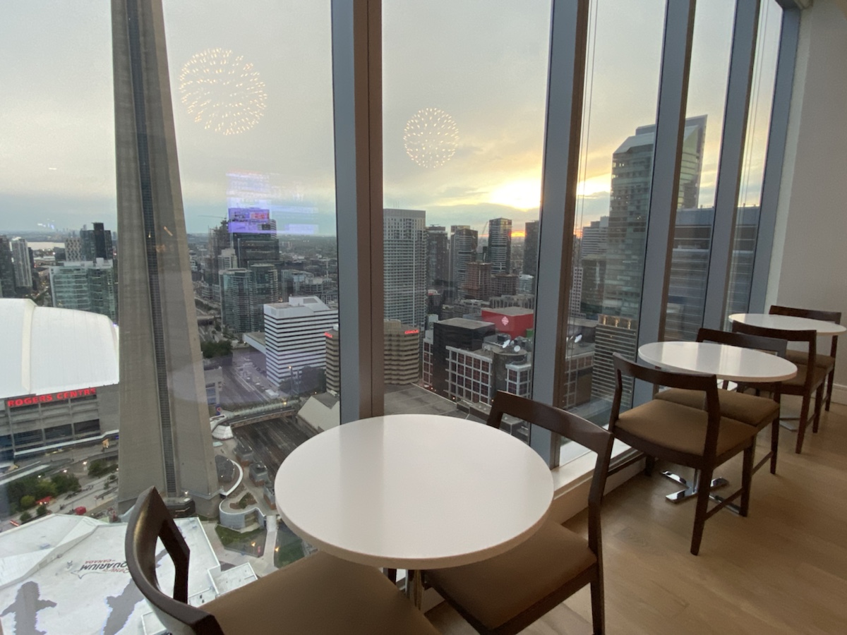 a table and chairs in a room with a view of a city