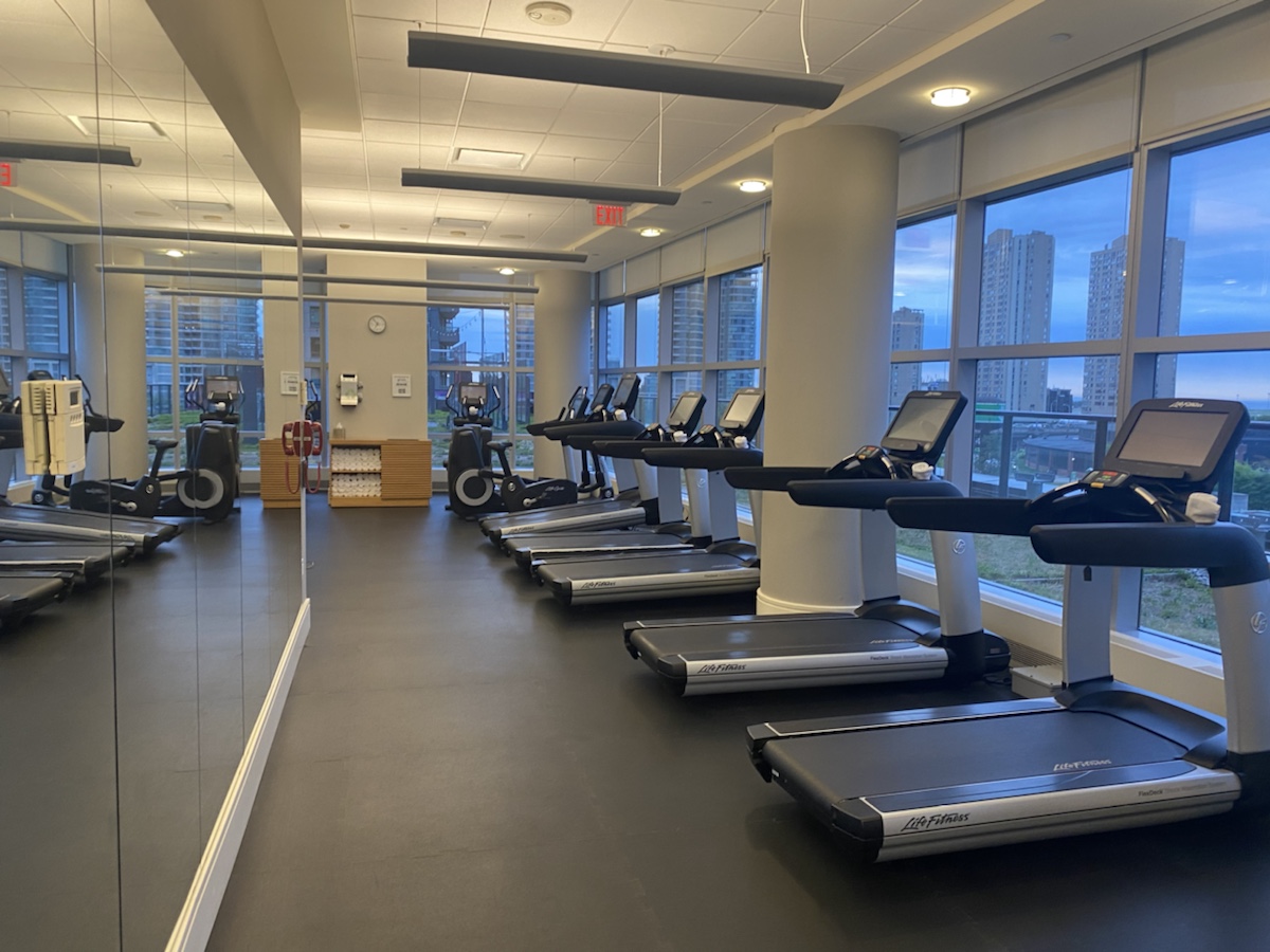 a room with treadmills and windows