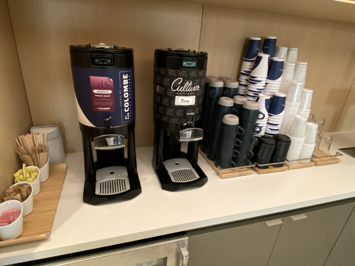 a coffee machine and cups on a counter