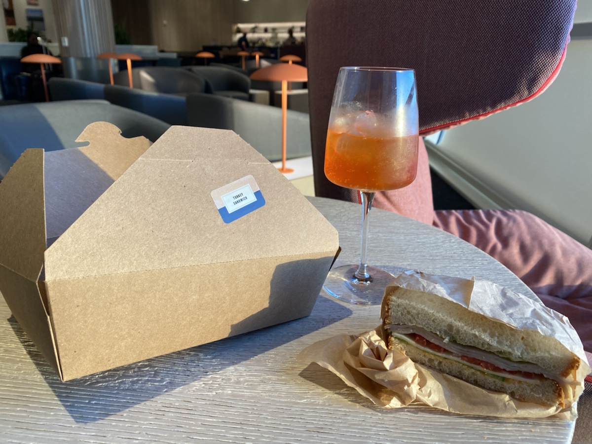 a sandwich and a glass of liquid on a table
