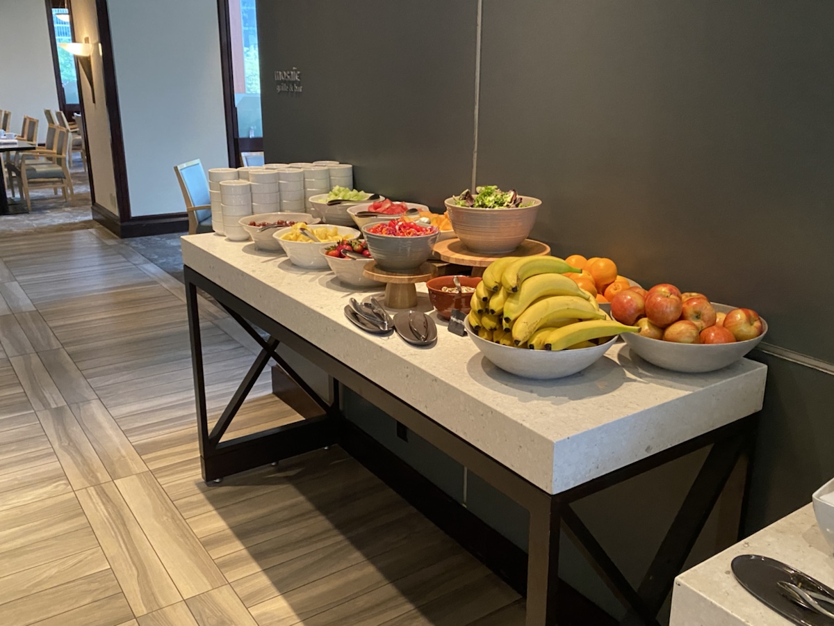 a table with bowls of fruit and bowls of food