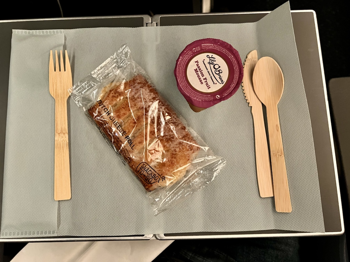food on a tray with a plastic bag and spoons
