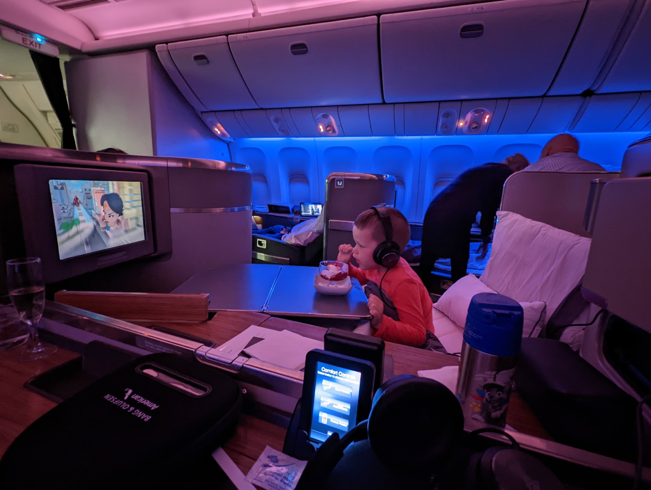 a child sitting in a chair in an airplane