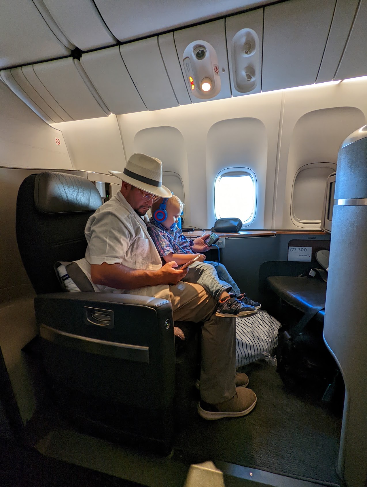 a man and baby sitting on an airplane