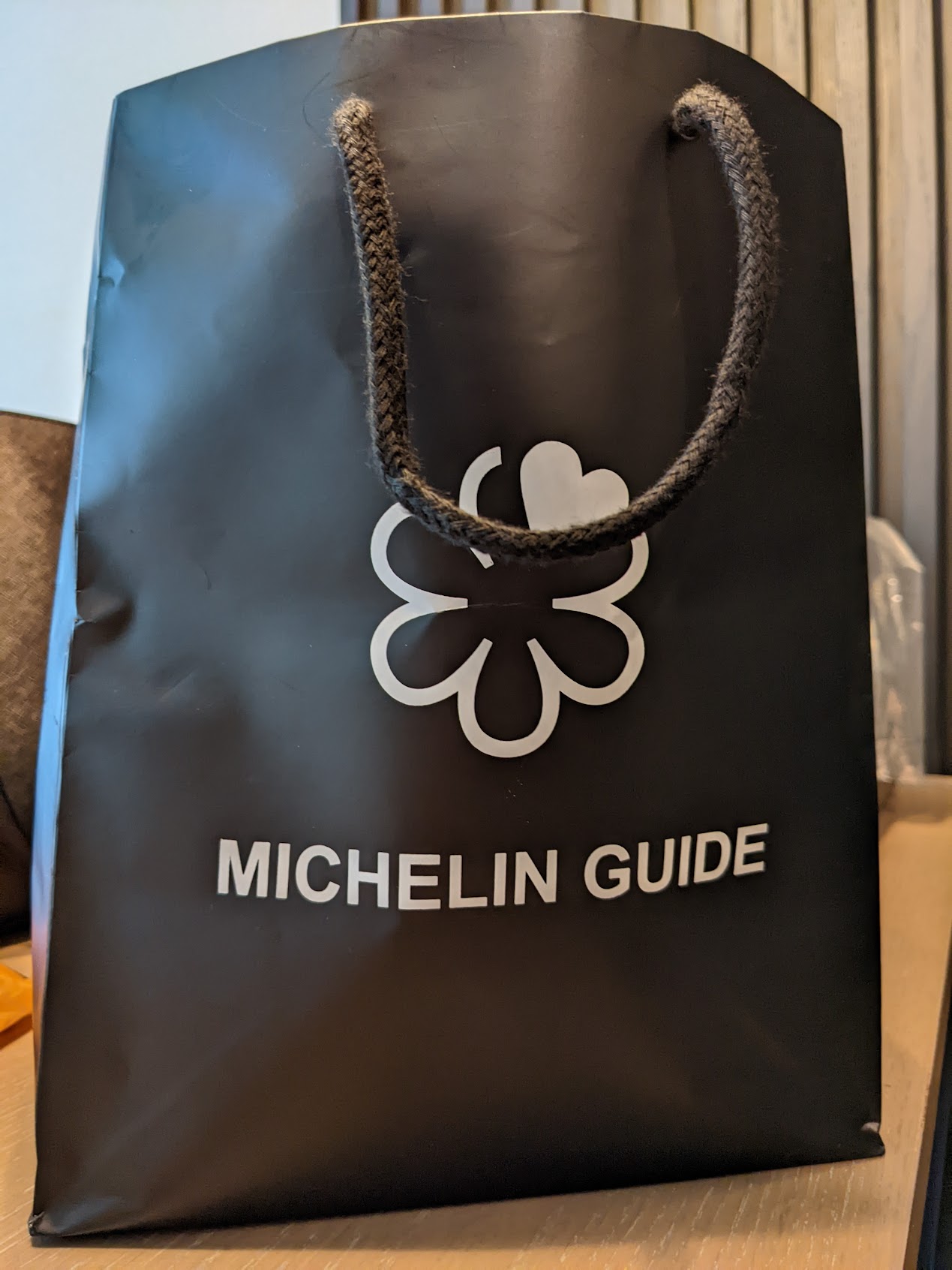 a black shopping bag with white text