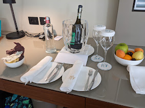 a table with plates and glasses and a bottle of wine