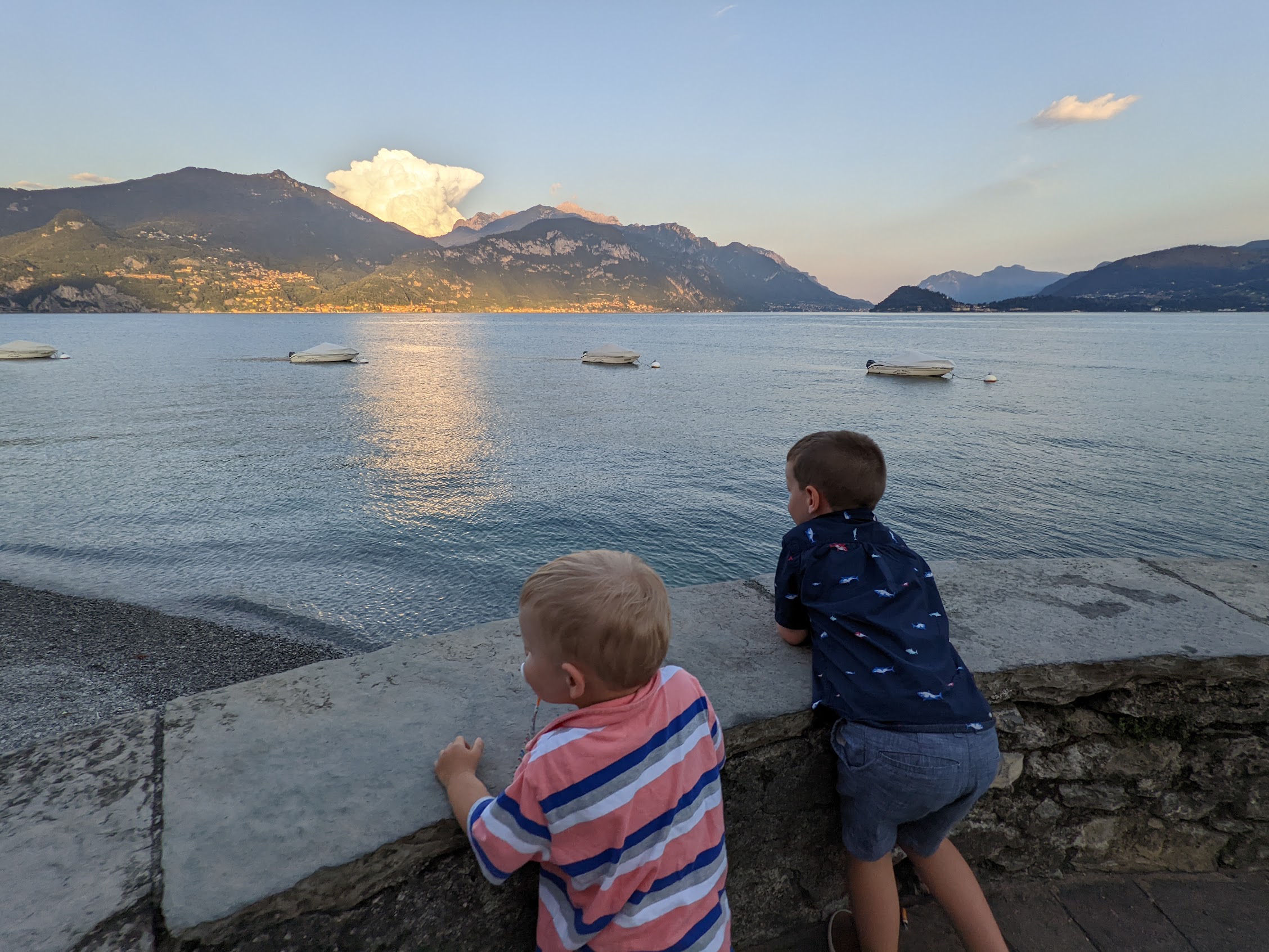 two boys looking at a body of water