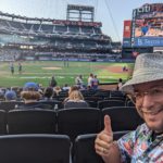 a man taking a selfie in a baseball stadium
