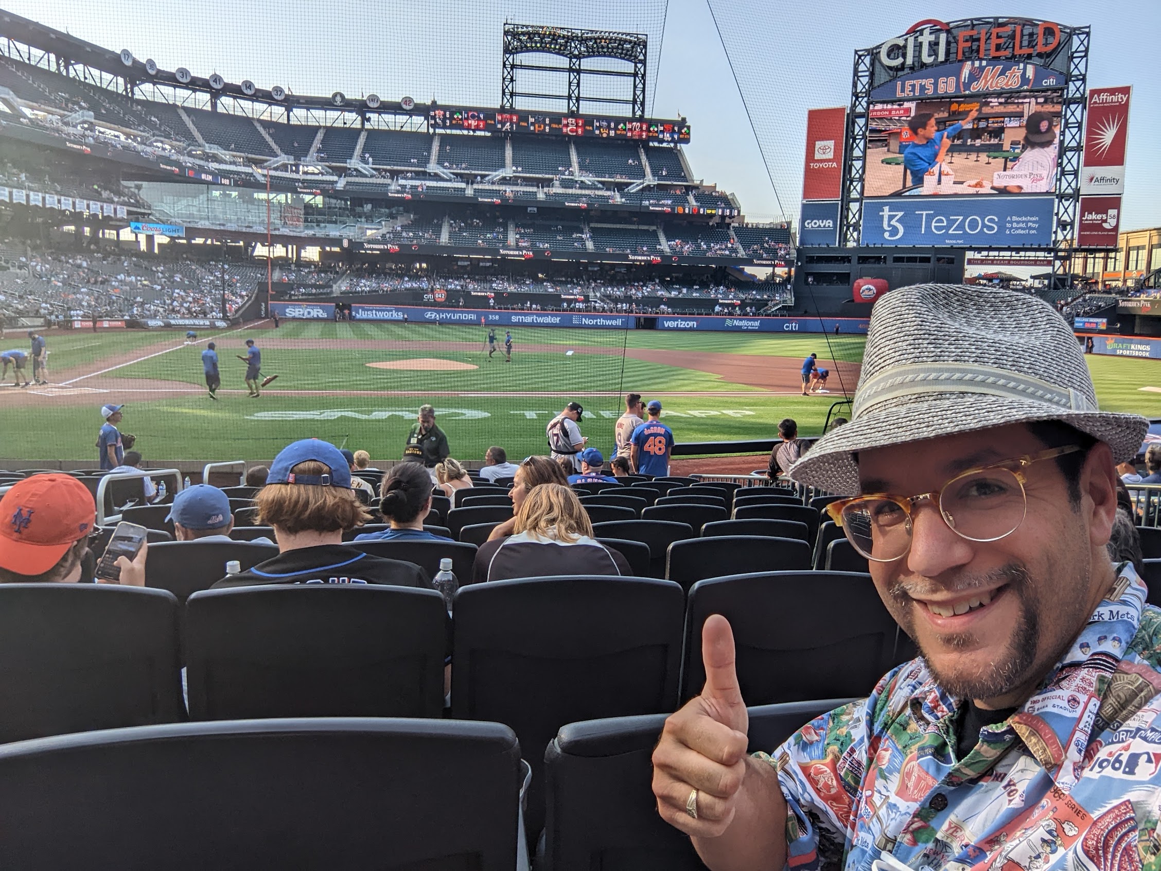 a man taking a selfie in a baseball stadium