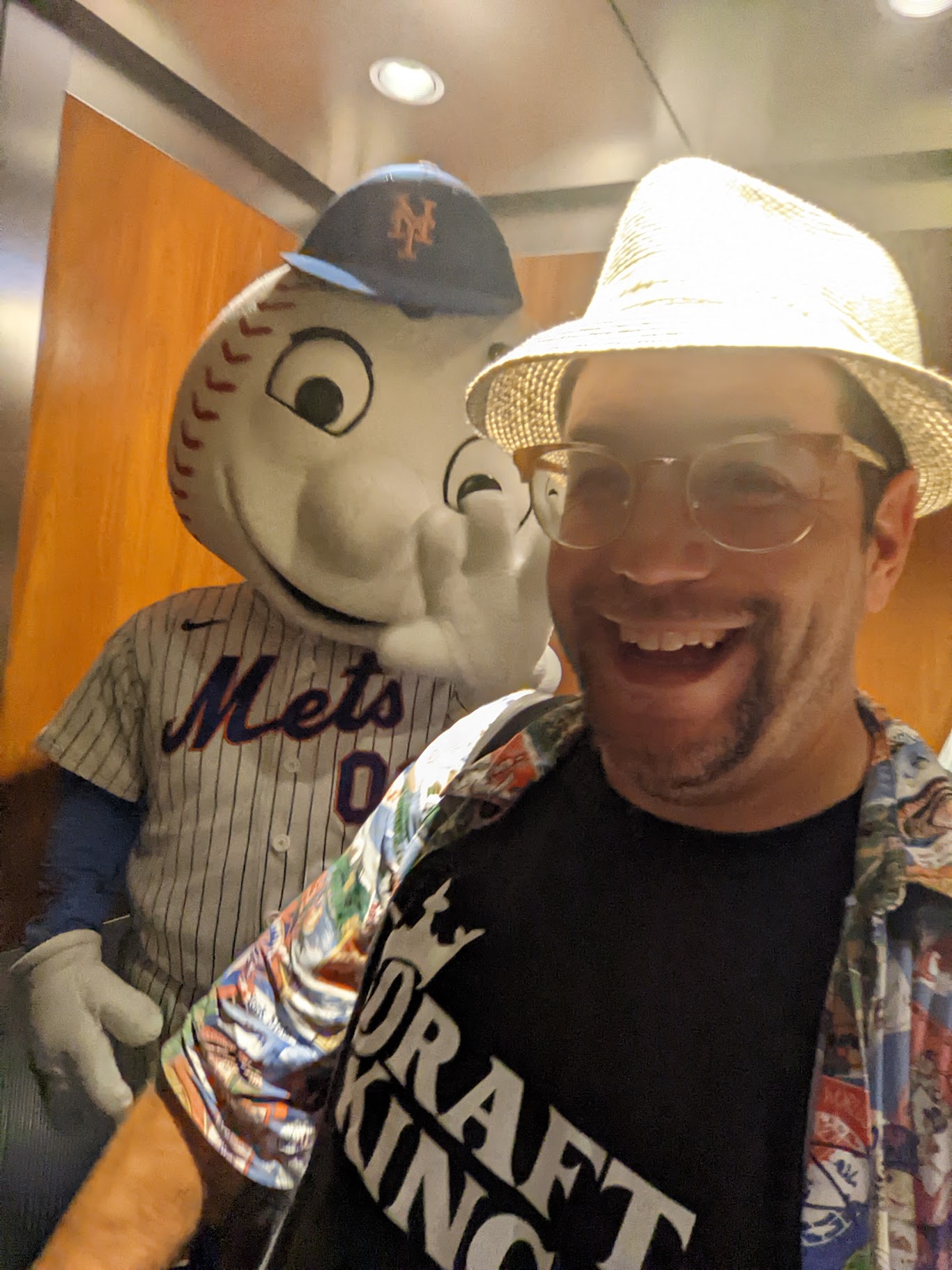 a man smiling with a mascot