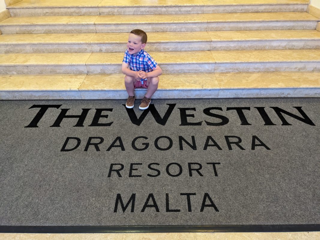 a boy sitting on stairs