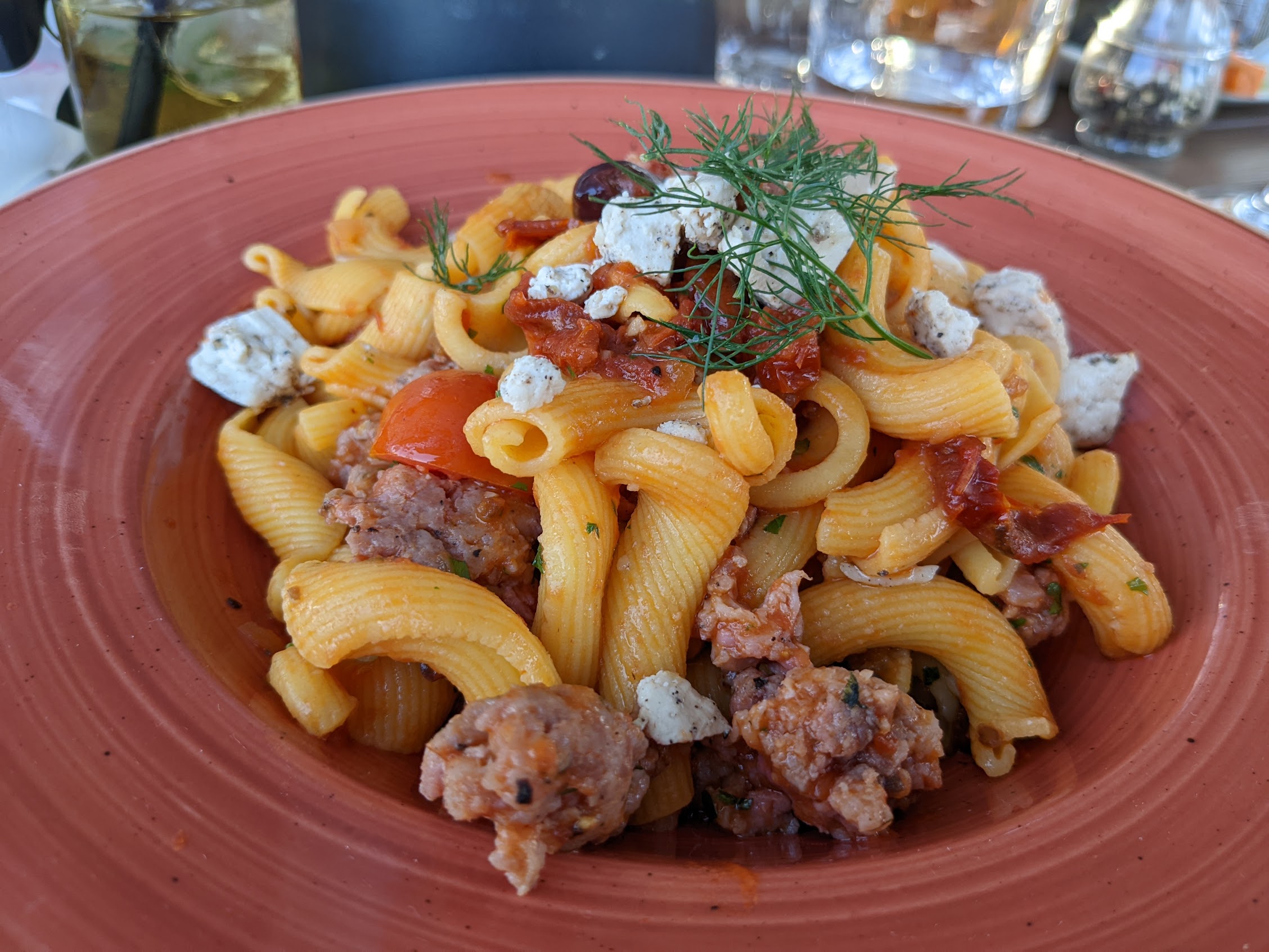 a plate of pasta with meat and vegetables